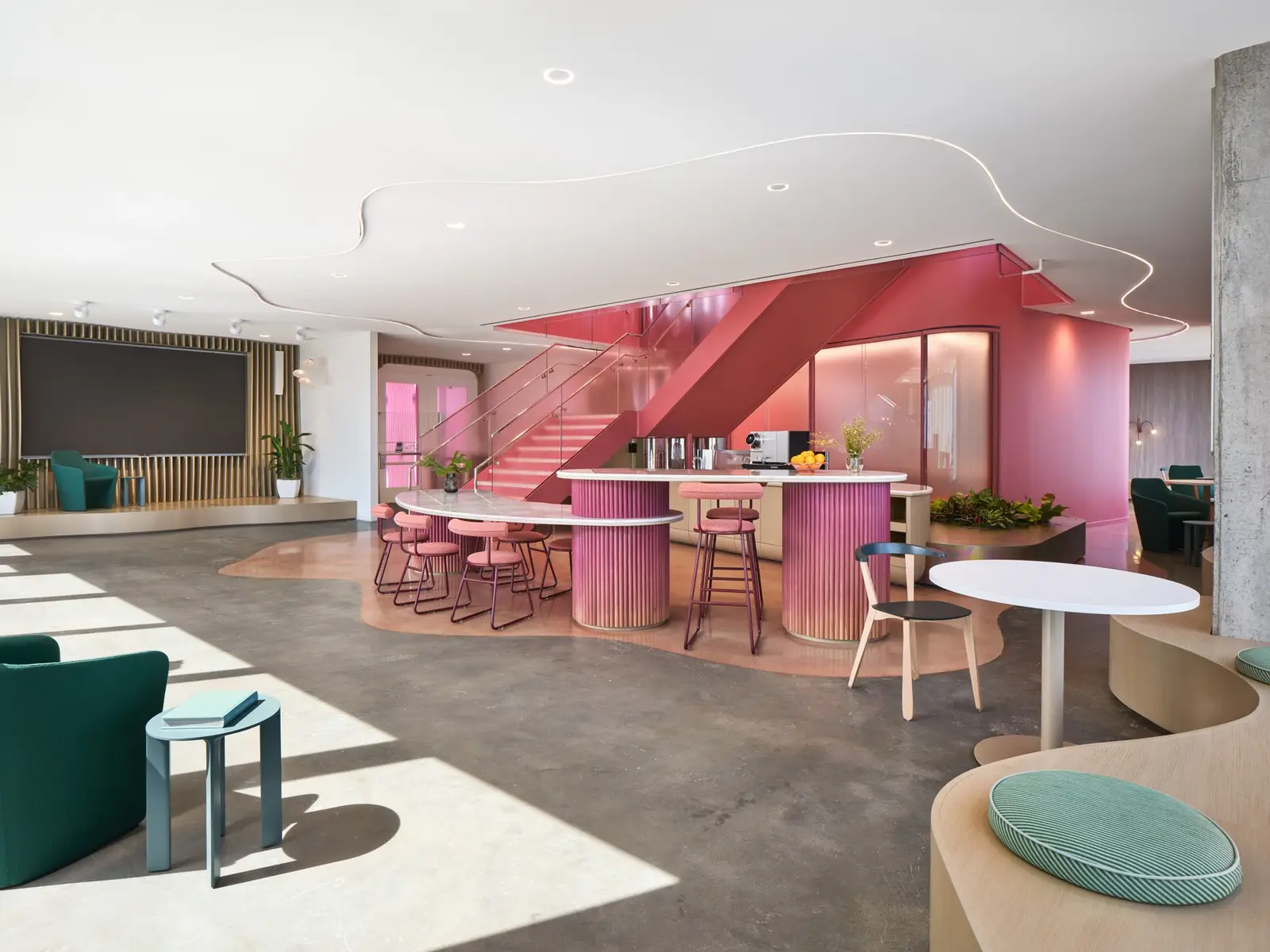 TikTok open office lounge with a pink stair and curved counters