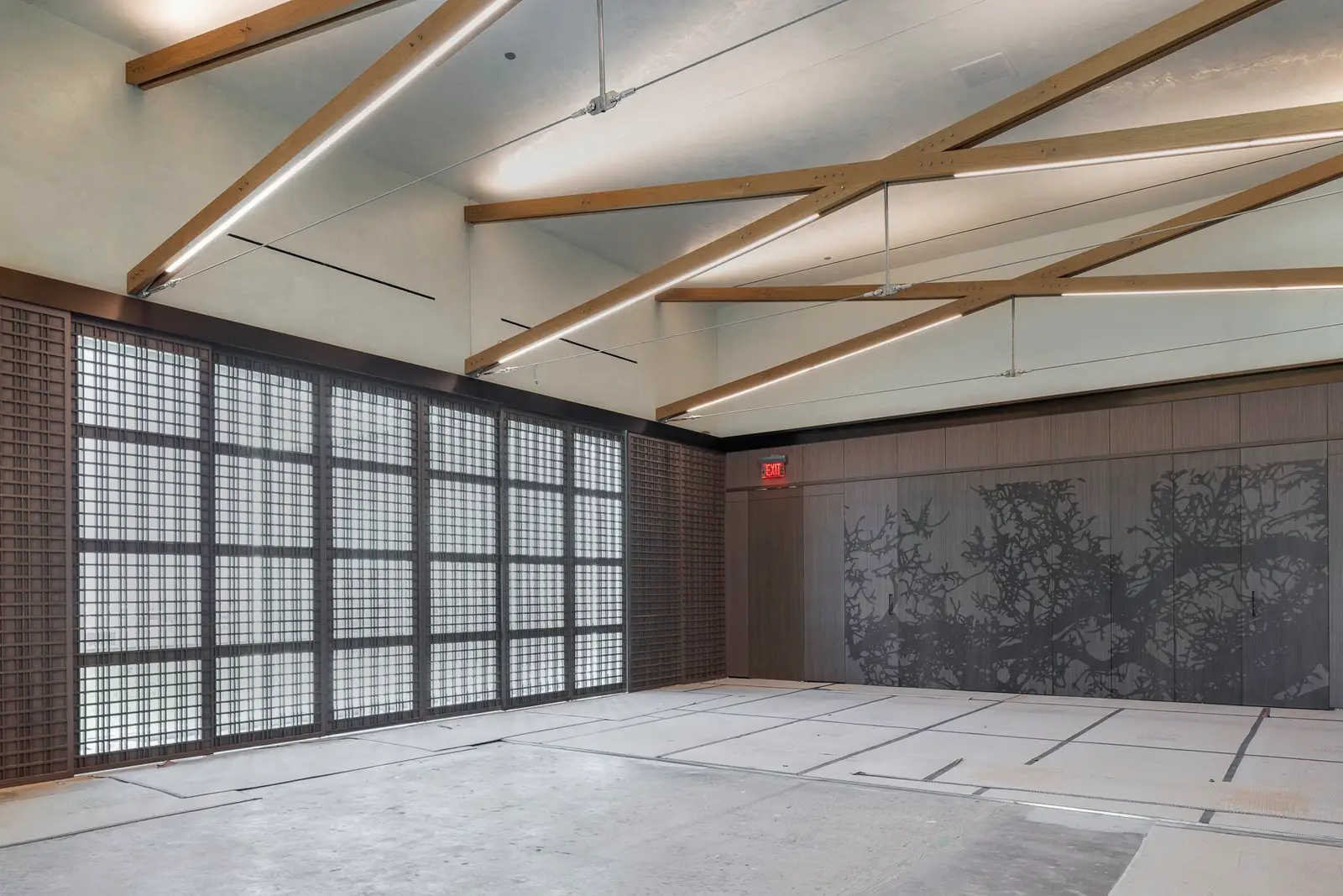 Undisclosed Project large room with exposed wood beams and wood-framed windows