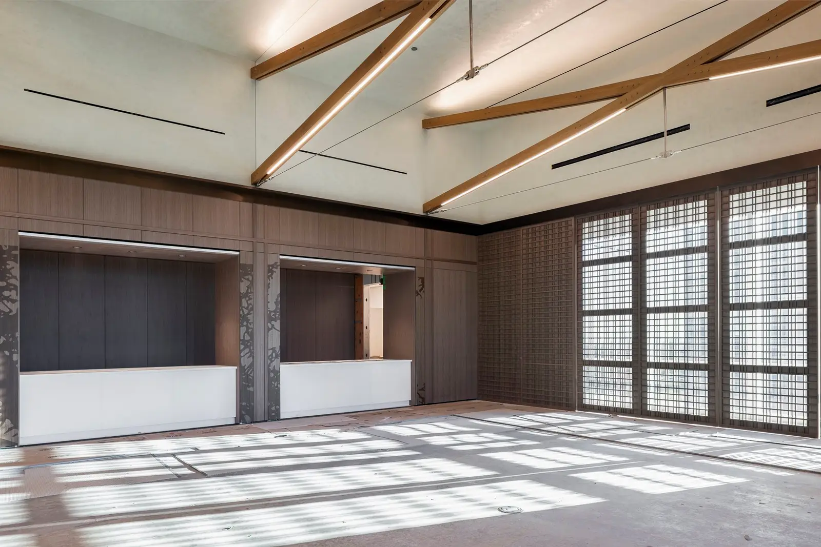 Undisclosed Project large room with wood beams, a wall of windows and a counter opening