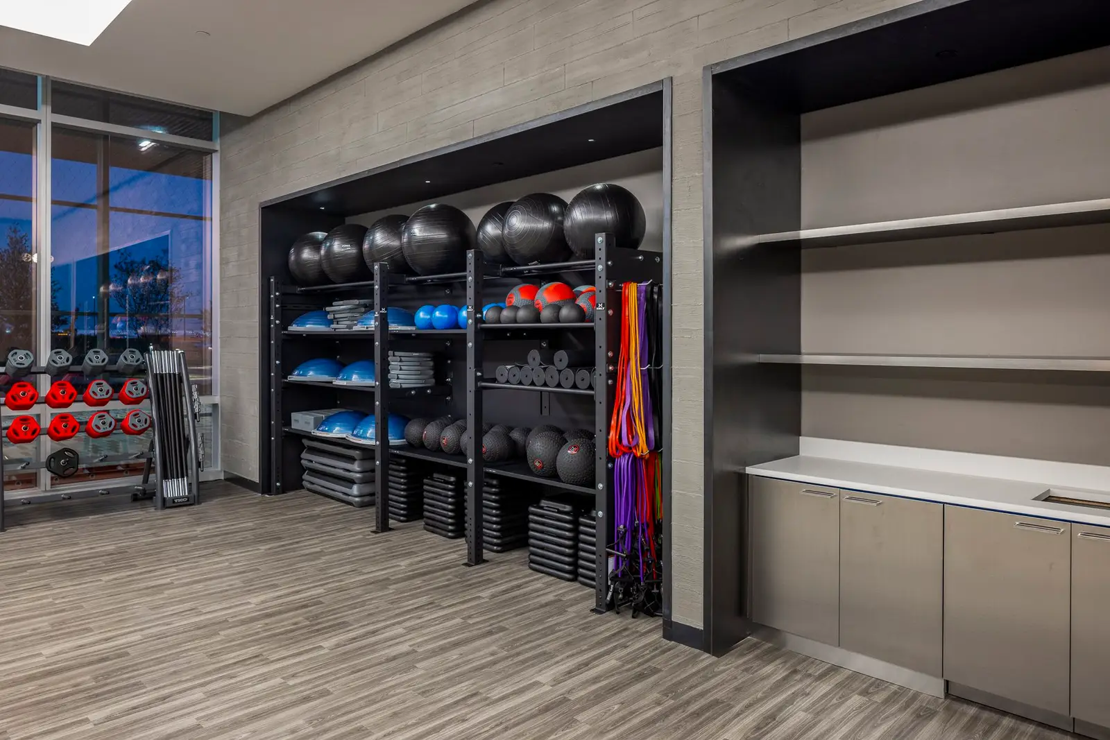 Undisclosed Project fitness room with equipment storage shelves and built-in cabinets