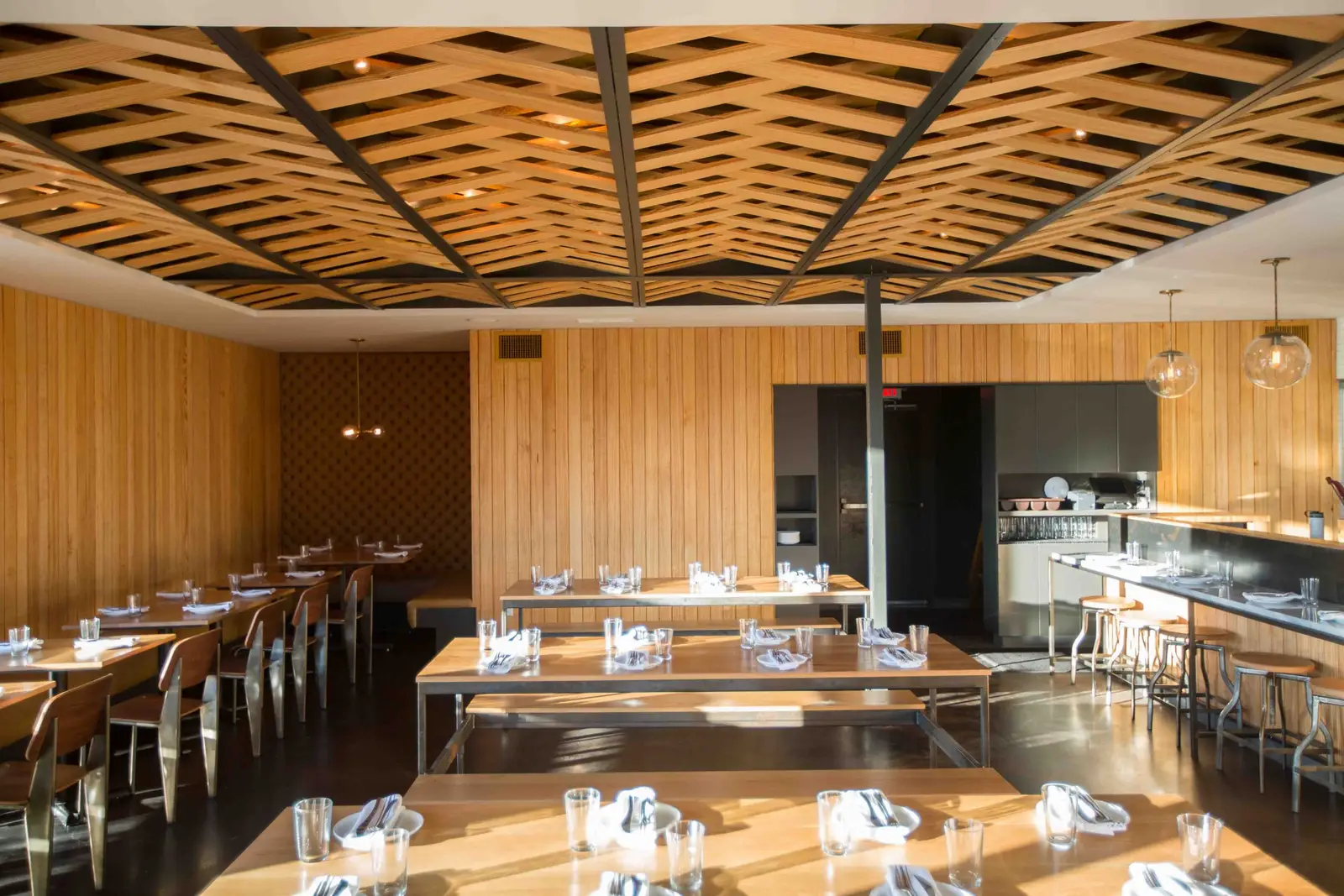 Unit-D Pizzaria dining room with a woven wood and steel ceiling and a wood wall