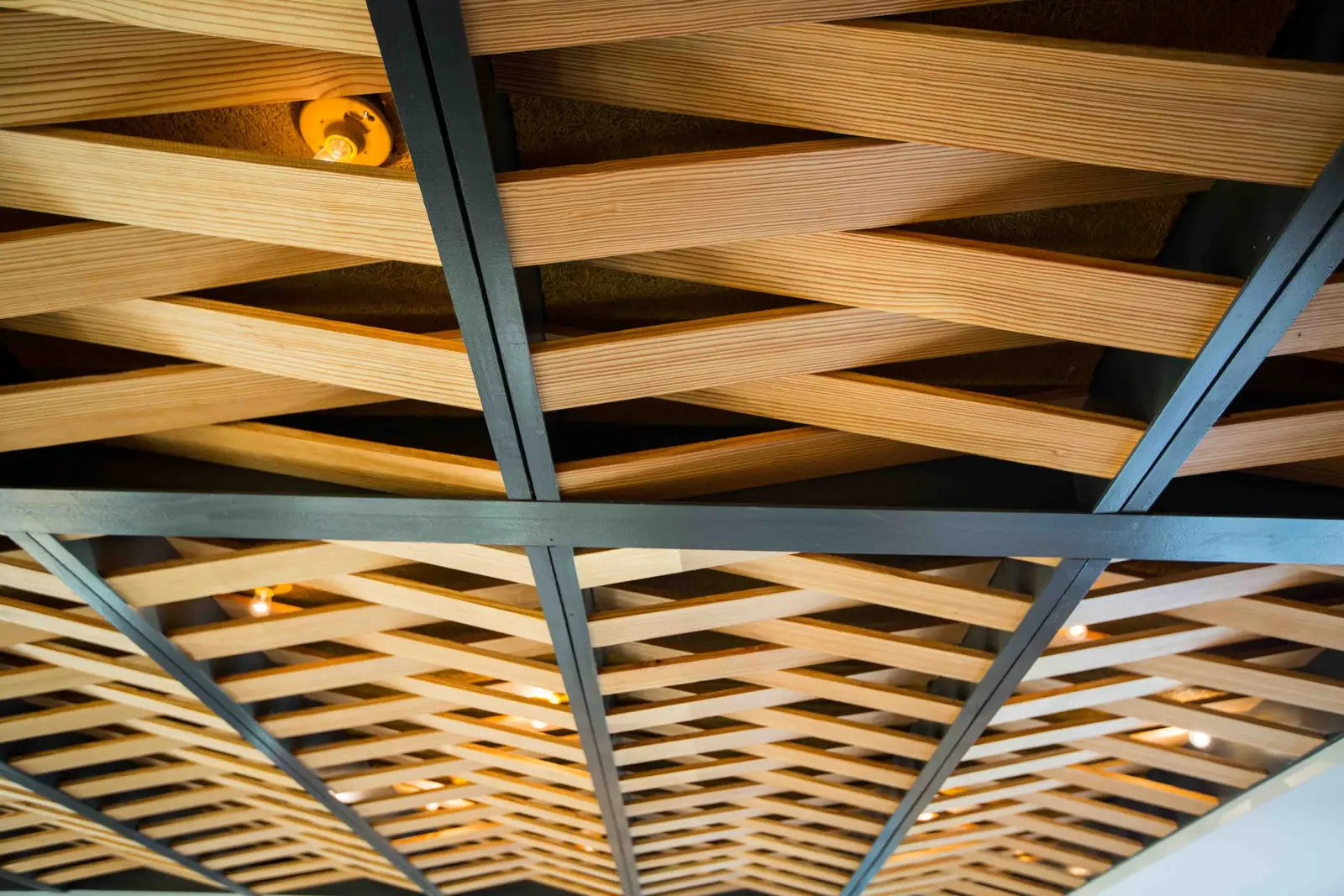 Unit-D Pizzaria woven wood and steel ceiling grid, close view