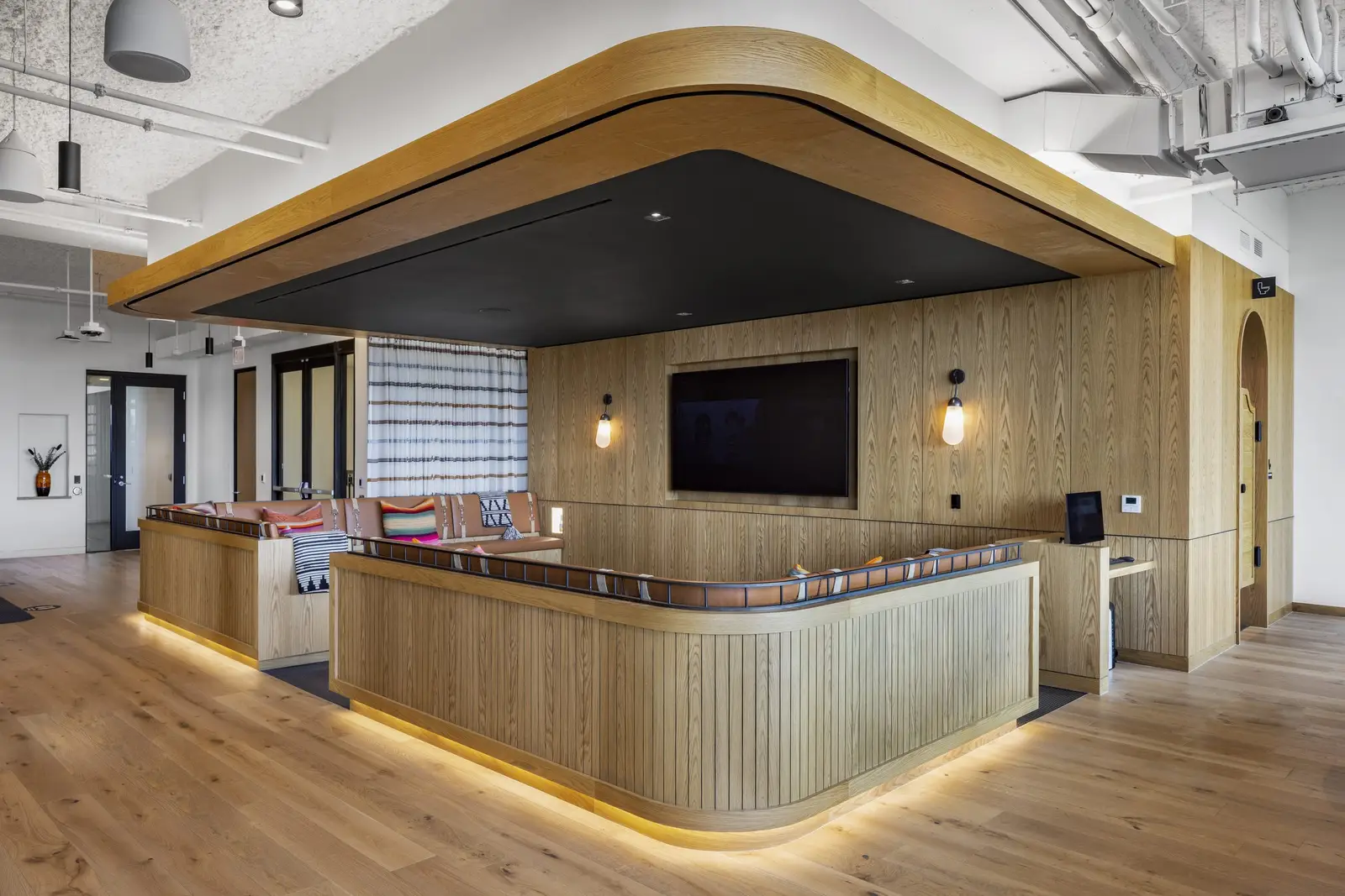 Unity curved wood-front counter under a wood soffit