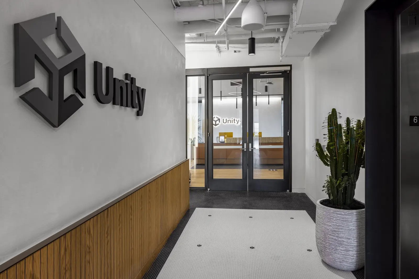 Unity entry hall with a wall-mounted Unity sign and wood wainscot