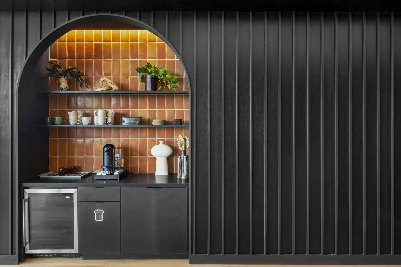 Unity arched niche with shelves on a dark wall