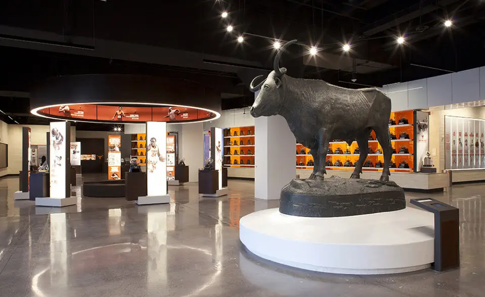 University of Texas Hall of Fame exhibit hall with a dark bull sculpture on a white platform
