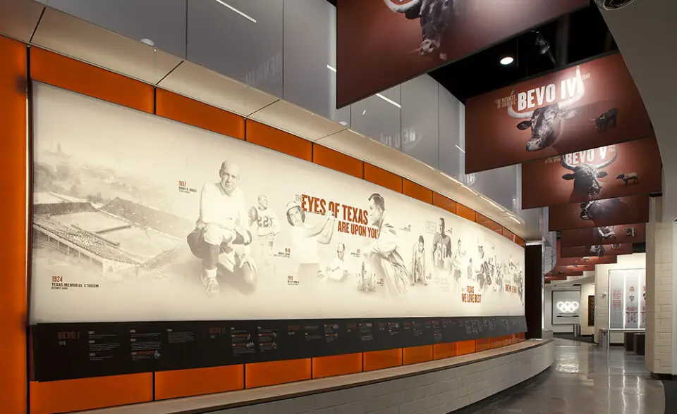 University of Texas Hall of Fame curved timeline wall with orange trim