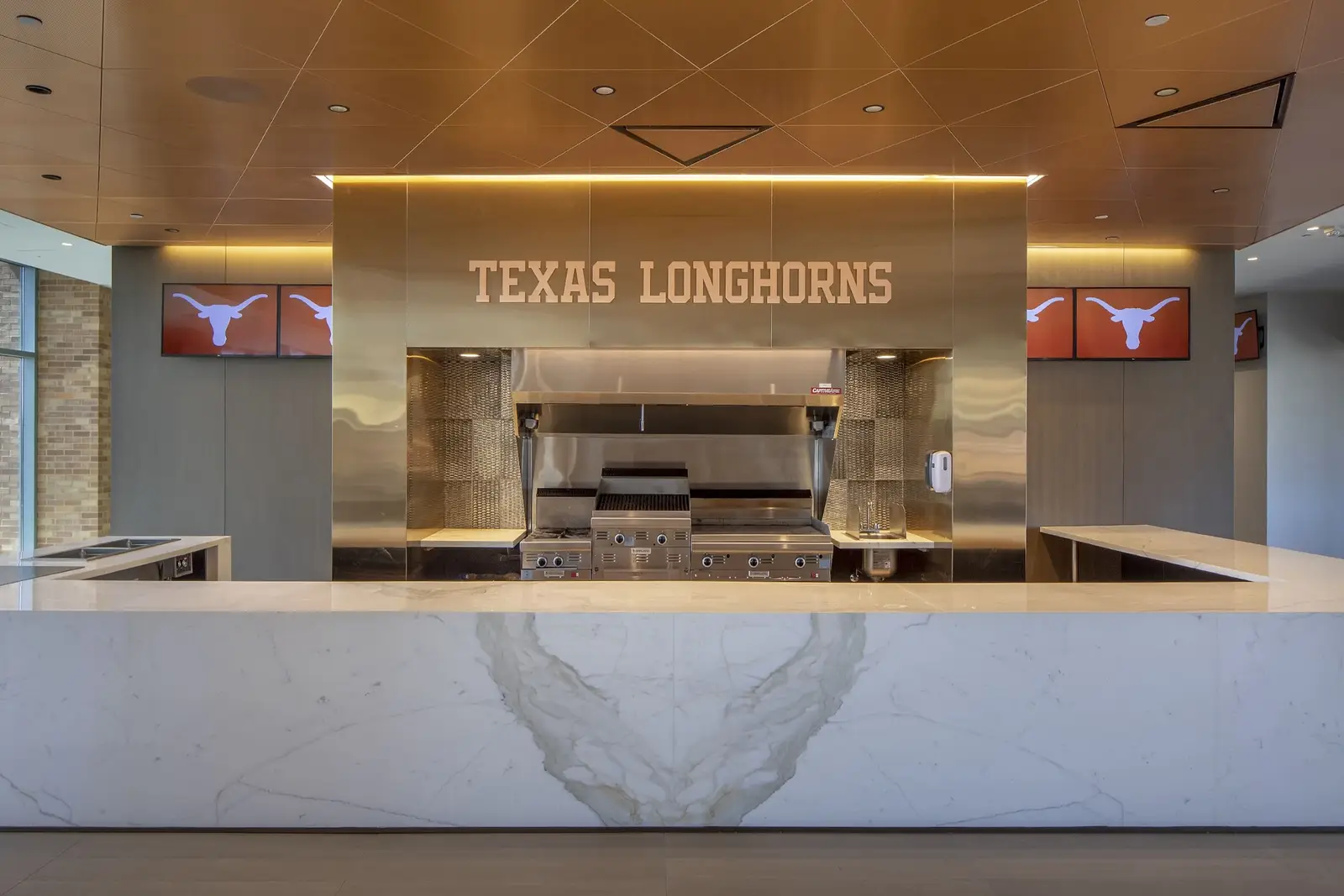University of Texas South End Zone concession counter with a white stone front and a TEXAS LONGHORNS sign