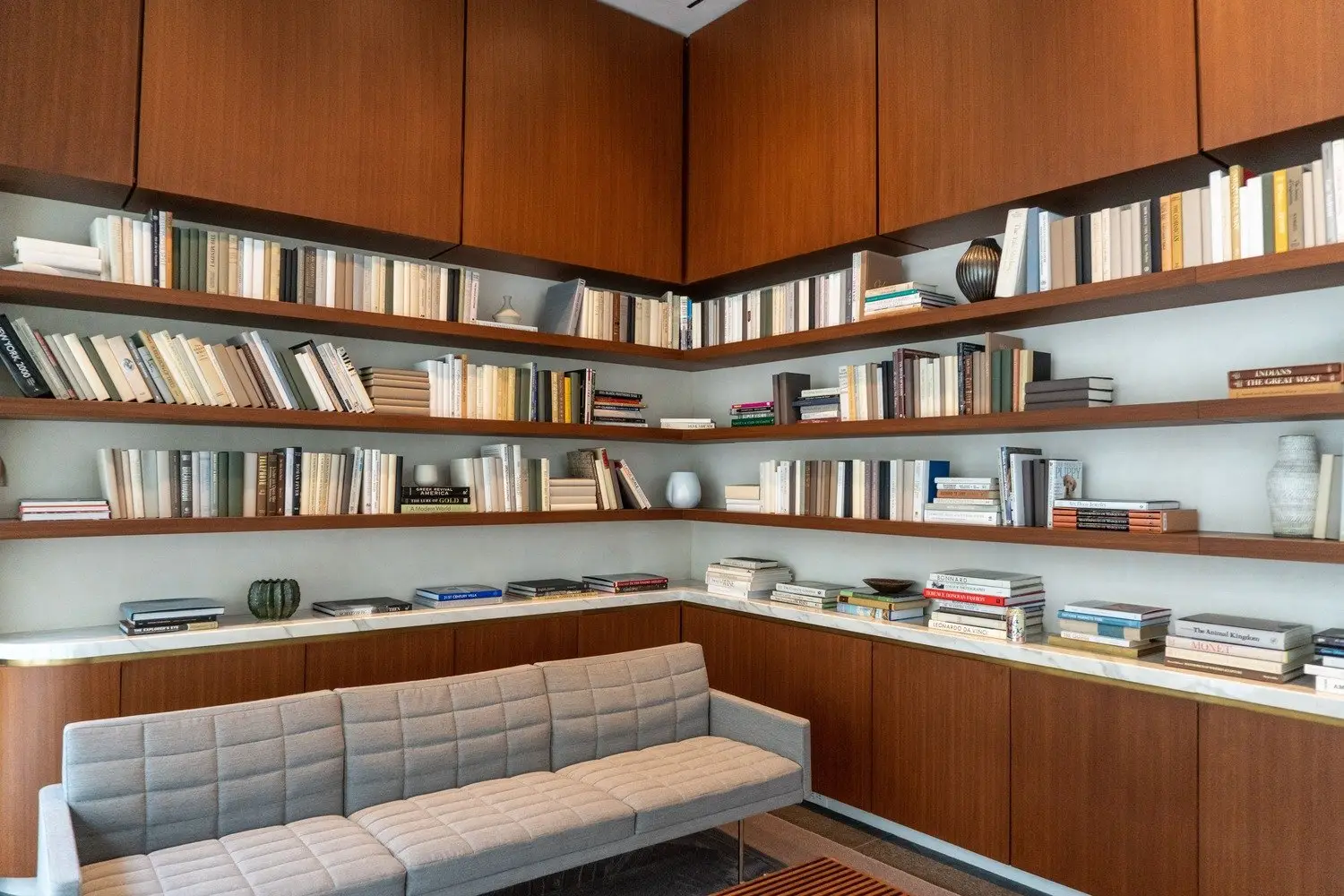 Westlake Dermatology built-in wood cabinets and open bookshelves above a gray sofa