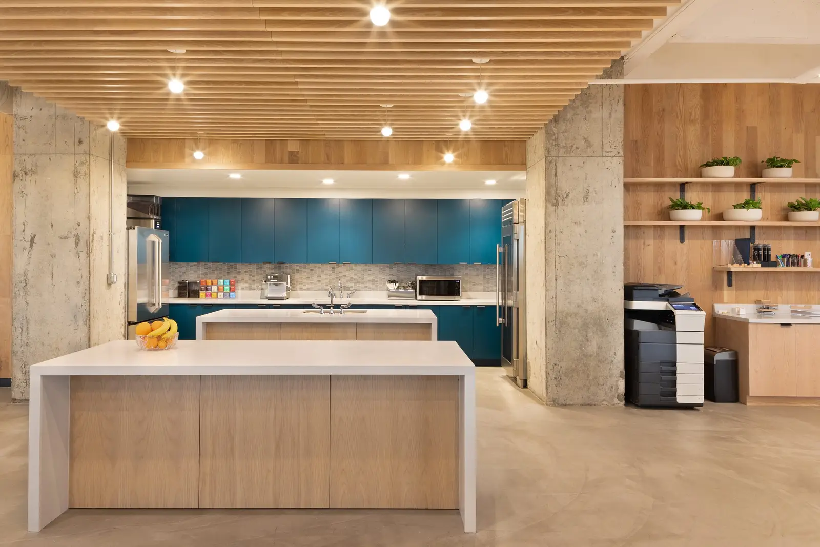 Workrise (formerly Rigup) kitchen with a white island, teal cabinets and a wood slat ceiling